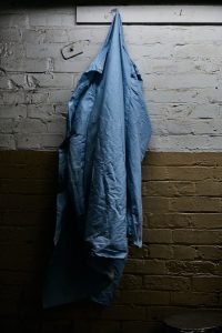 blue windbreaker hanging on hook